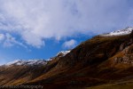 Clouds, blue sky and mountains with a tip of snow